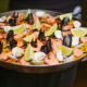 Homemade seafood paellas accompanying barrel tastings